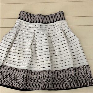 Maje Jiselle Jacques skirt. White background with black, black,tan,  gold flecks